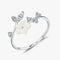 Délicate bague en argent ornée d’une fleur en nacre blanche et de feuilles serties de cristaux.