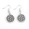 Boucles d’oreilles pendantes en argent présentant le motif géométrique sacré de la fleur de vie.