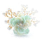Délicate broche en forme de fleur de couleur menthe, ornée de perles et de brins de cristal.