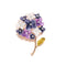 Broche florale présentant des fleurs en émail violet, bleu marine et blanc avec des centres en strass, une tige et une feuille en métal doré.