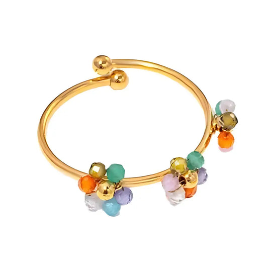 Bracelet manchette ouvert en or avec des grappes de perles colorées.