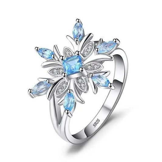 Bague flocon de neige en argent avec pierres précieuses bleues.