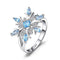 Bague flocon de neige en argent avec pierres précieuses bleues.
