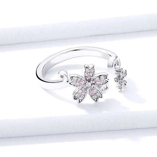 Bague fleur en argent avec accents roses.